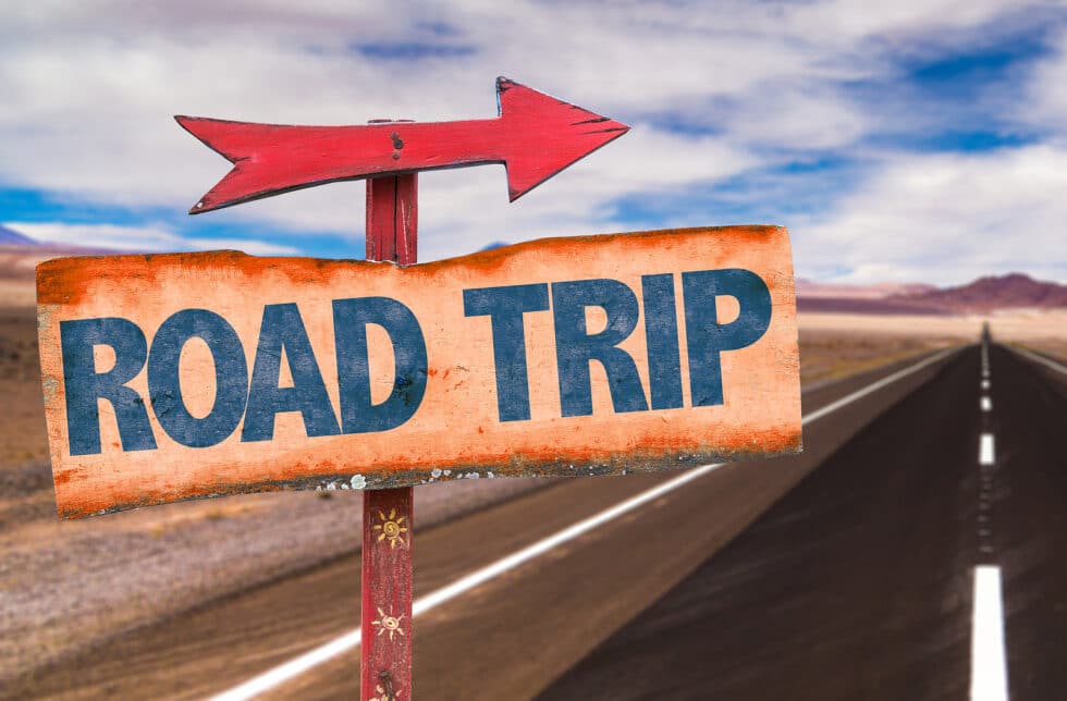 Boardwalk Resort Vacations road trip route sign beside an open highway.